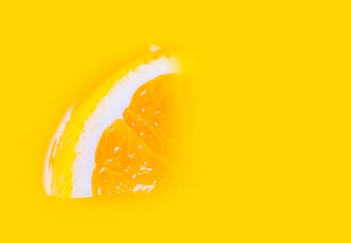 orange slice lying in a yellow orange juice