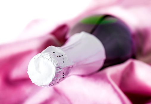 sparkling champagne wrapped in pink fabric closeup