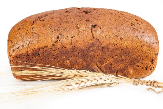 brown bread with ears of wheat on a white background isolated