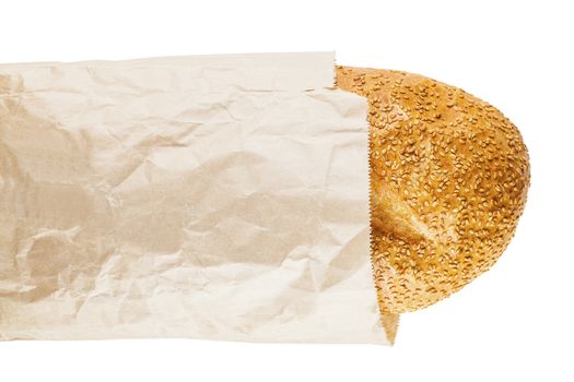 bread with sesame seeds in a paper on a white background isolated