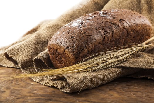 a loaf of black bread lying on the old cloth