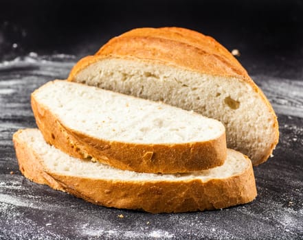 sliced Baton dial on a dark background with flour