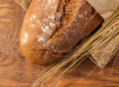 loaf of bread close-up on a wooden background