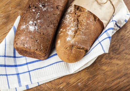 two loaves of bread on a wooden background