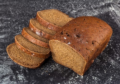 sliced loaf rye bread on a dark background