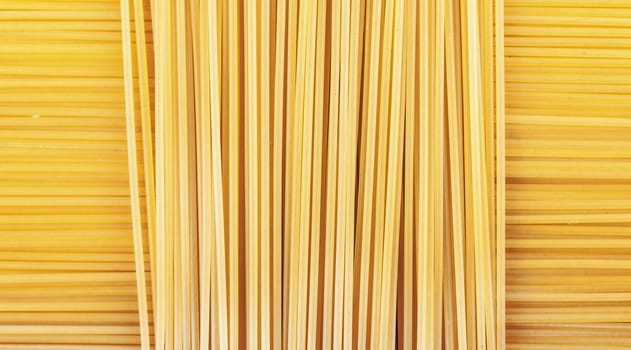 background the raw pasta lying horizontally and vertically