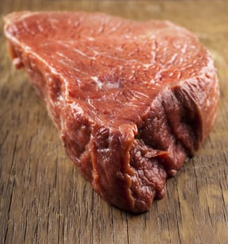 raw beef fillet closeup on wooden background