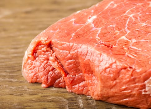 fresh beef fillet closeup on wooden background