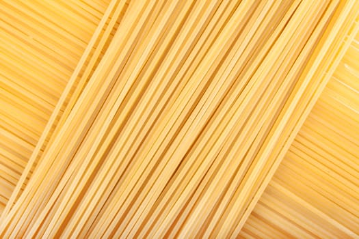 yellow background the raw pasta lying diagonally