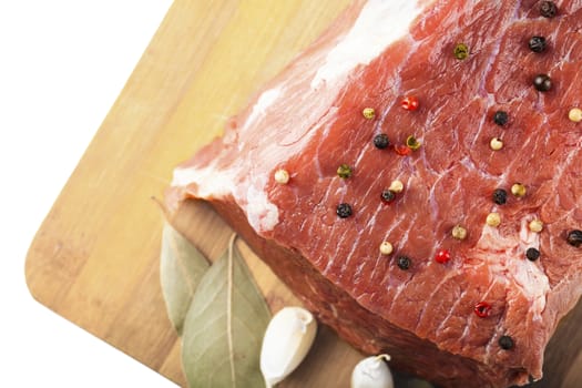 beef filet with spices closeup on a wooden board, white background