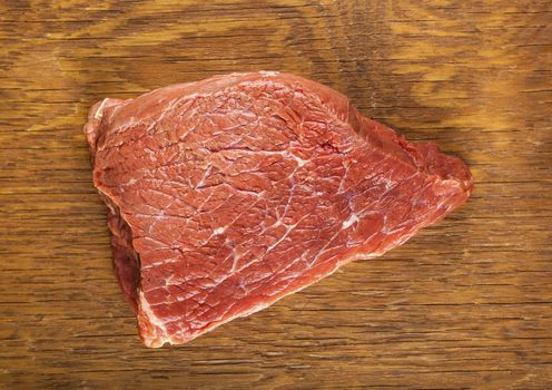 raw fillet of beef on wooden background