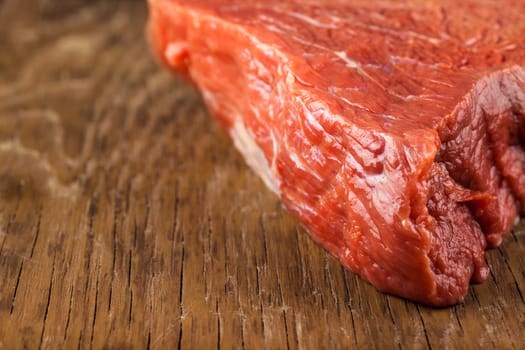 fillet of beef closeup on wooden background