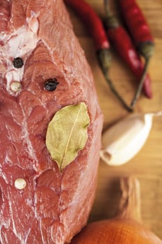 beef filet with spices close-up on a wooden board