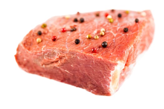raw beef filet with spices isolated on a white background