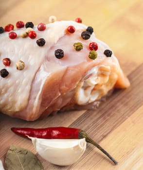 raw chicken feet on wooden board with spices closeup