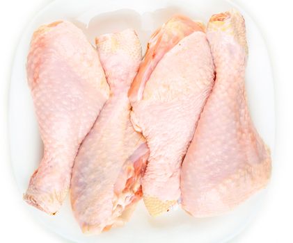 Fresh raw chicken legs on a white background