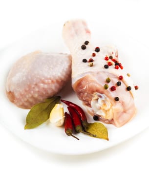 chicken feet on the plate with spices closeup, white background