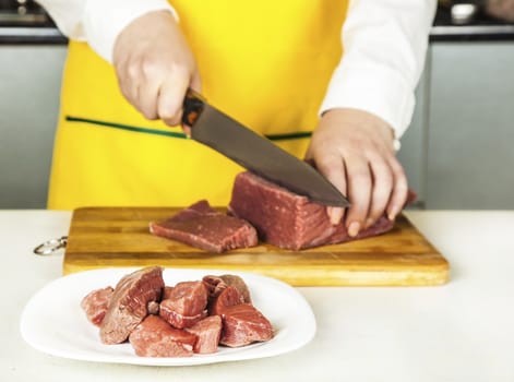 woman cook chopped fresh fillet of beef knife