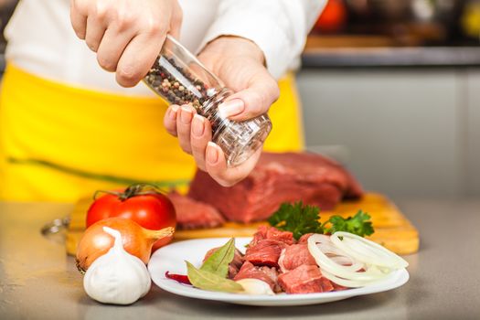 cook peppers beef fillet on a table spices and vegetables