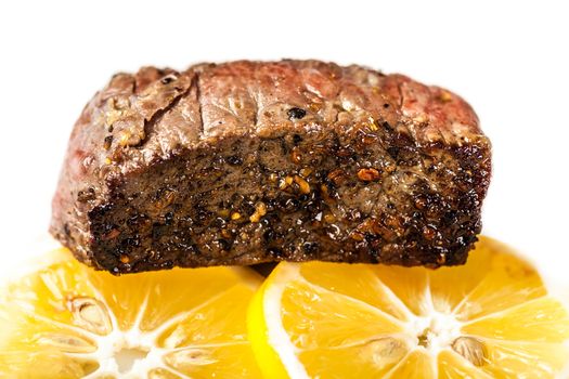 piece of roasted meat with slices lemon 