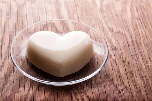 vanilla jelly in the form of heart on wooden background