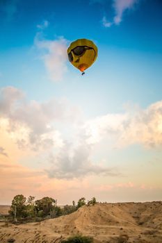 yellow balloon flying high above the earth