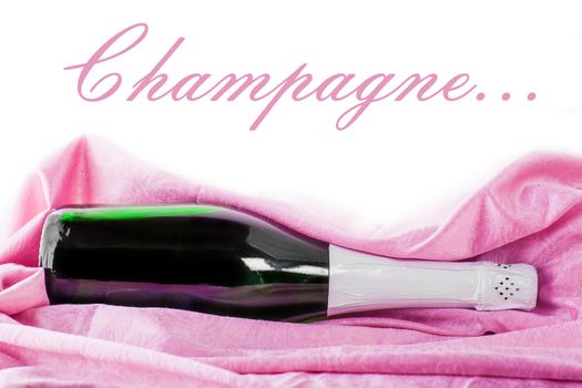 closed bottle of champagne wrapped in pink tissue