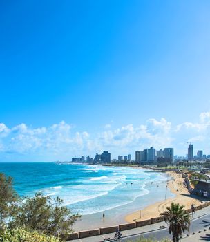  beach with waves on the background of the city