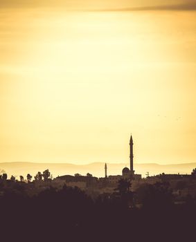 landscape Arab settlements with mosque at sunset