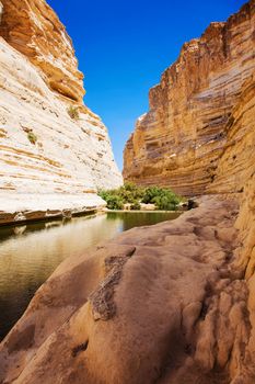 deep gorge with leaking at the bottom of the river and the blue sky