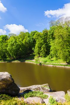 landscape forest and river with big stones on the shore