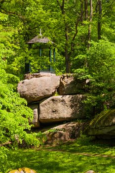 arbor on large rocky boulders and green forest