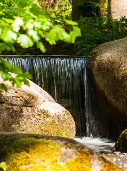 waterfall flowing over the stones closeup in forest