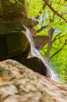 stream of water flowing along the a rock