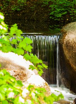 waterfall flowing over the stones closeup in forest