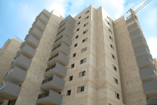 a new building under construction by day