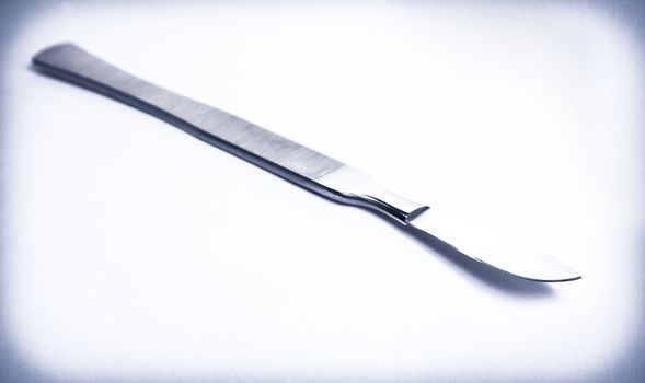 surgical scalpel on average light background
