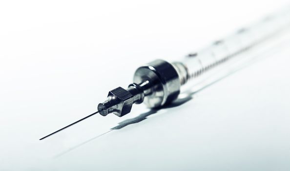 syringe and needle closeup medical background
