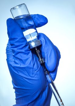 hand with a vaccine for injection, medical background
