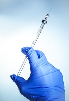 syringe with vaccine in hand experienced doctor 