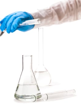 assistant pours reagent in the flask on a white background