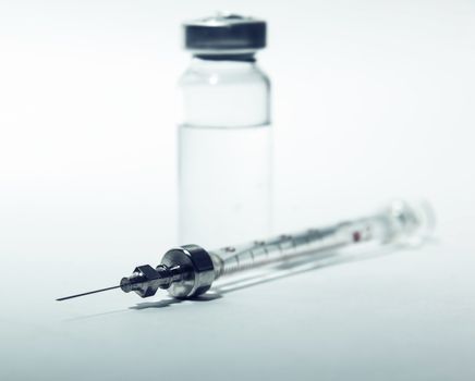 syringe with bottle closeup, medicine background