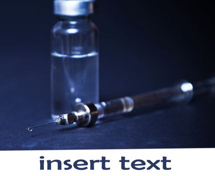 syringe with the vial on a dark background, medicine