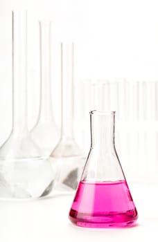 variety of glass flasks with reagents on a light background