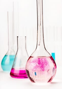 various flasks with reagents on white background