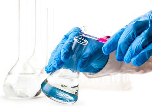 laboratorian reagent pours a flask on a white background