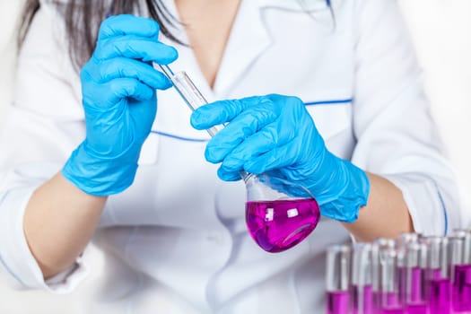 assistant works with reagents closeup on a light background