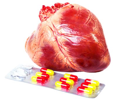heart with pills isolated on white background