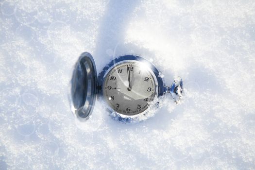 vintage watch lay on a snowy background