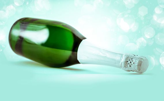 a bottle of sparkling champagne on a blue background